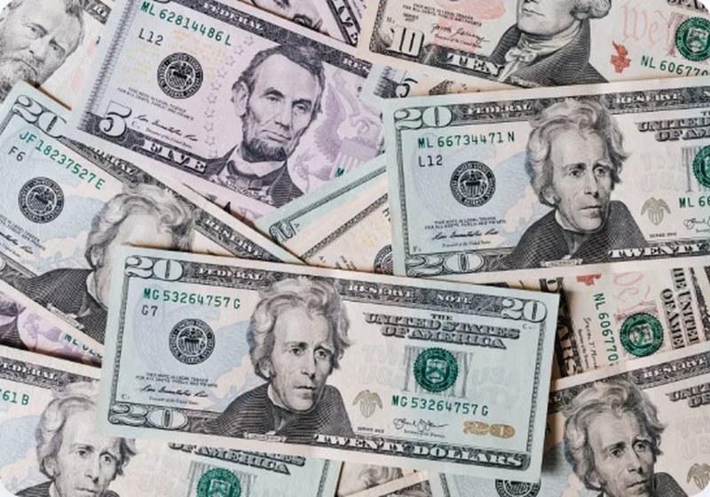 US dollar bills spread out — Varo Advance cash advance up to $500 instantly