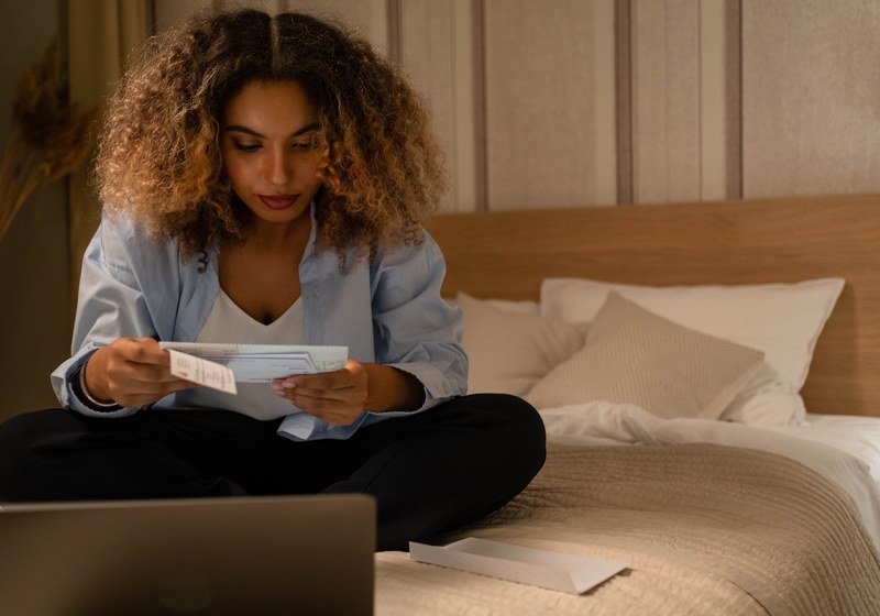 Woman reviewing her paycheck — Varo Early Direct Deposit up to 2 days early